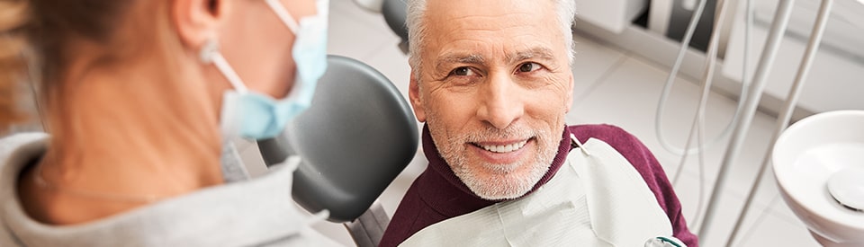 man in dentist chair smiling