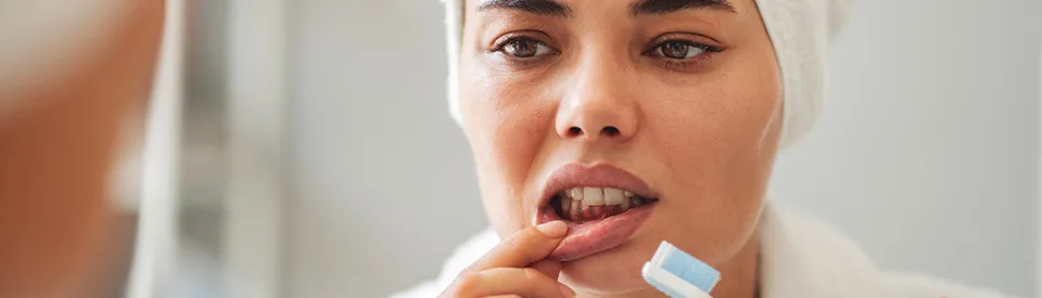 woman looking at her bleeding gums