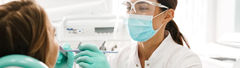 dentist inspecting patients mouth