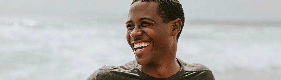 man smiling on the beach