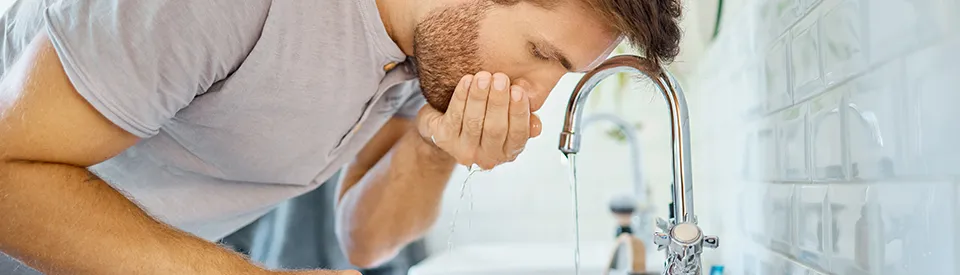 man rinsing out mouth