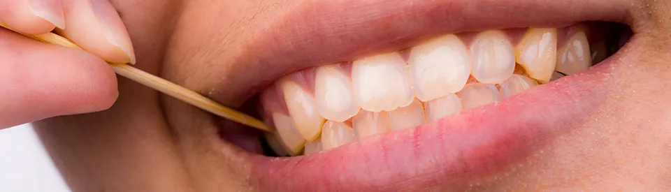 picking teeth with toothpick