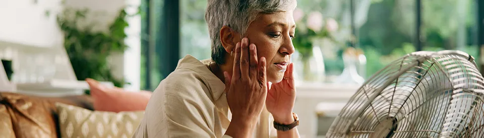 elderly woman holding jaw in pain