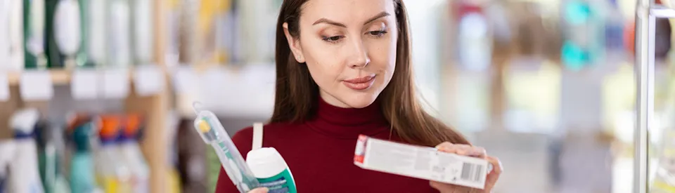 woman comparing dental products