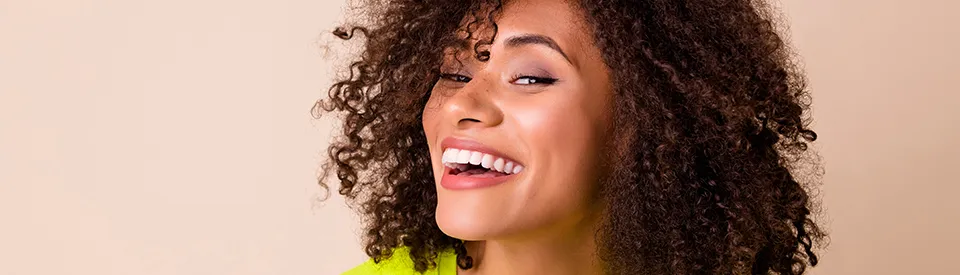 Smiling woman after a lost veneer repair