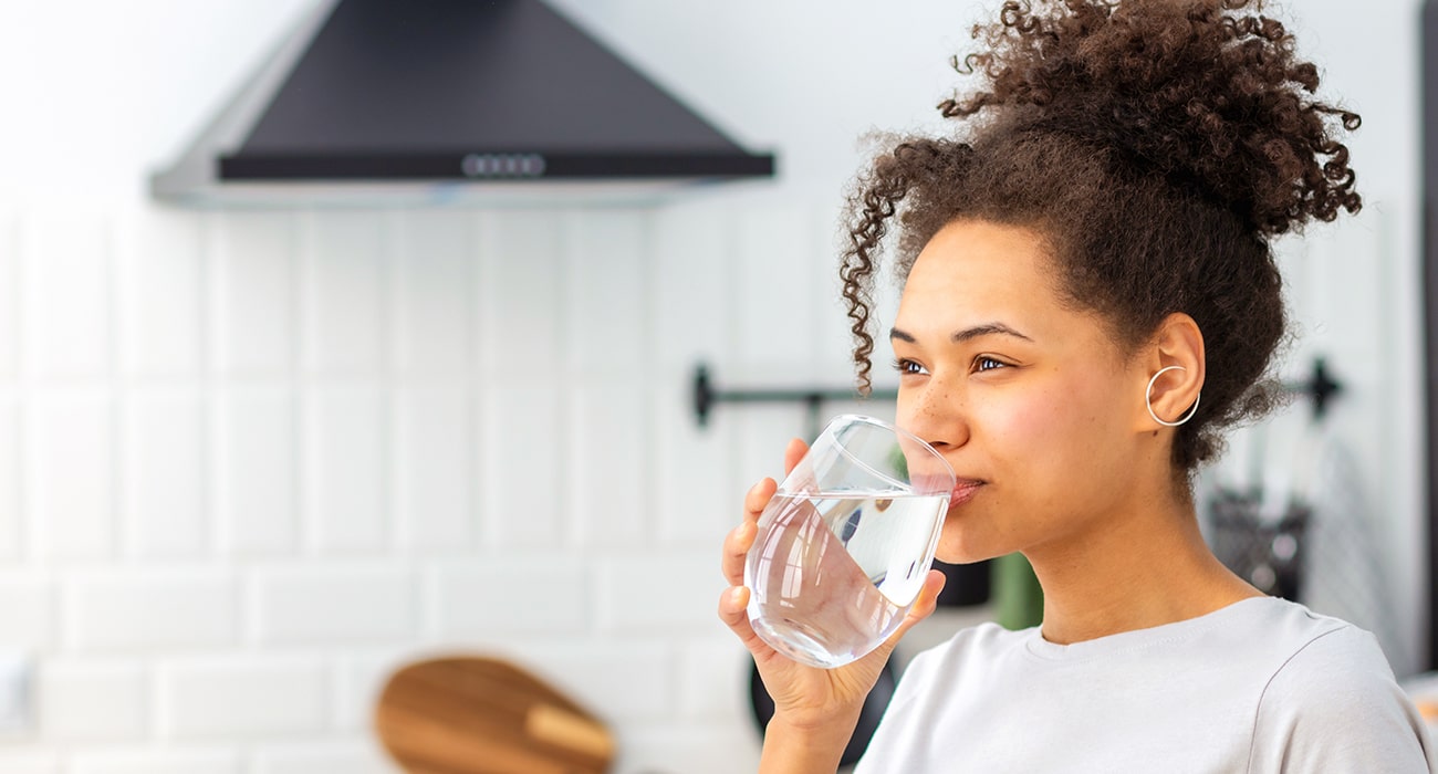 woman drinking from a glass of water