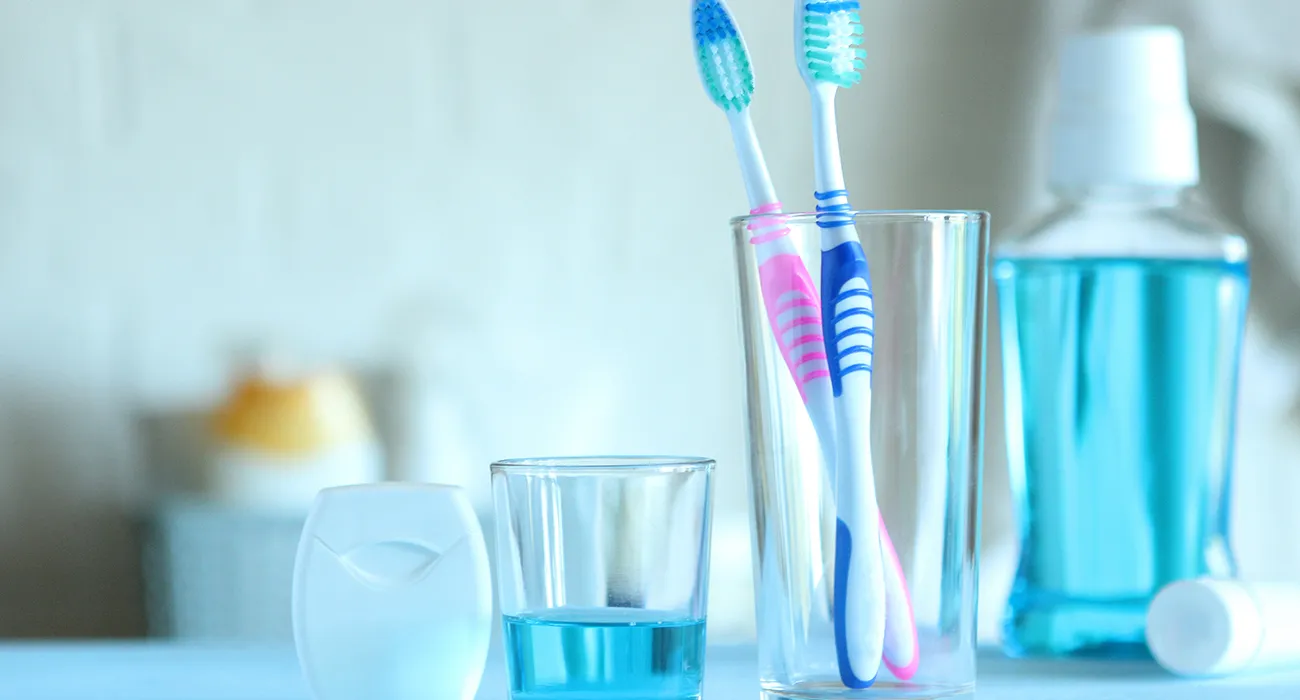 toothbrushes and mouthwash on the counter