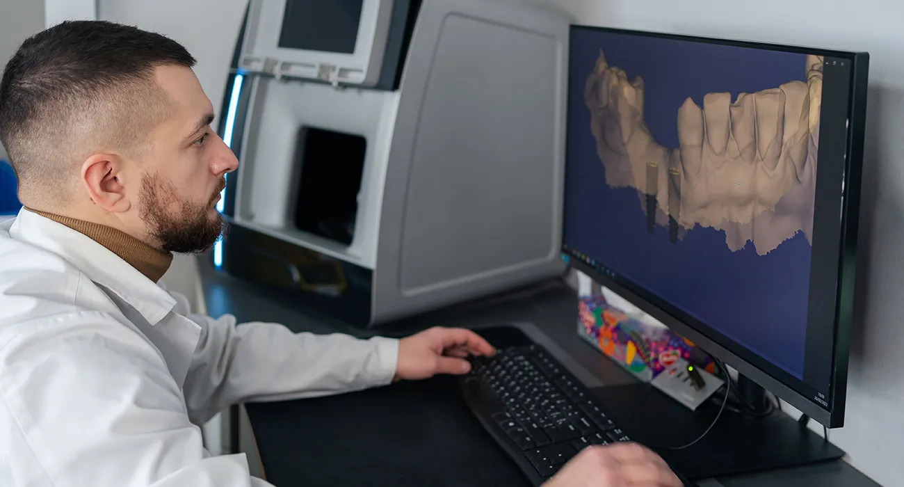 dentist inspecting x ray on computer