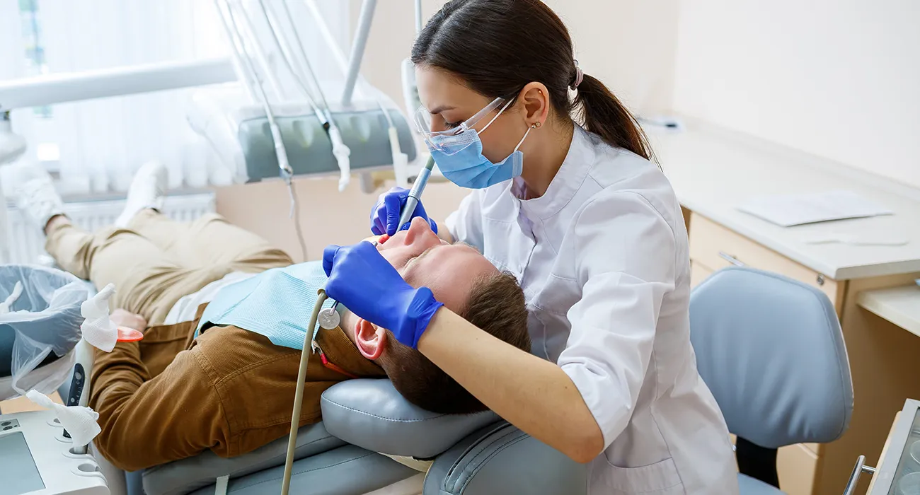 dentist inspecting a patients mouth