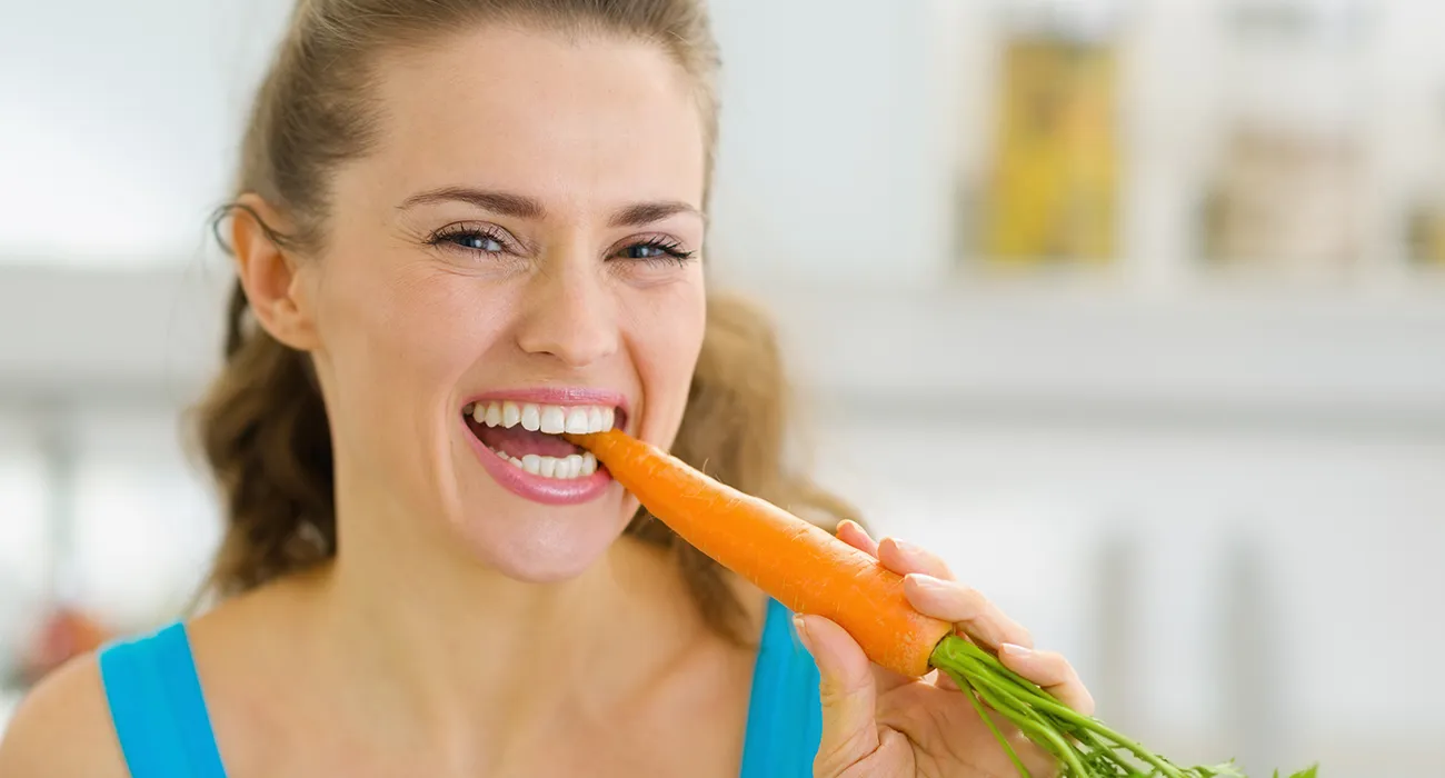 woman eating a carrot