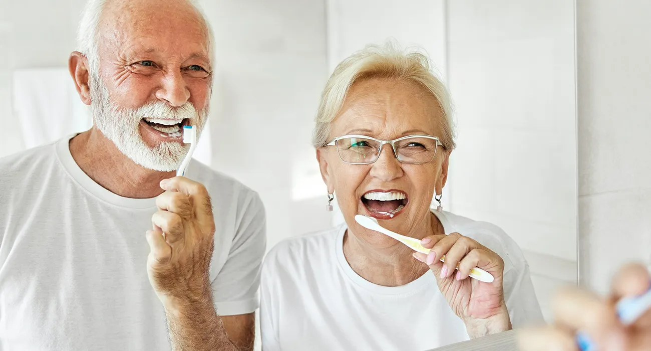 old couple brushing their teeth