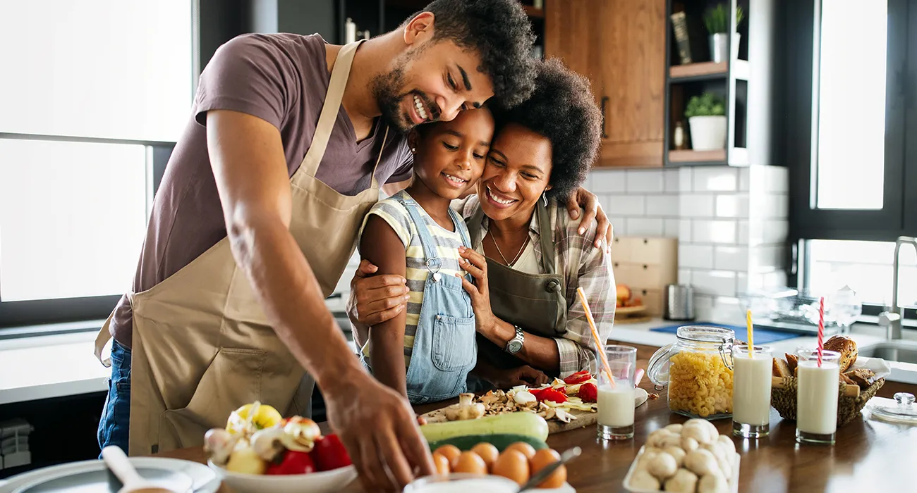 family preparing vegetables on counter