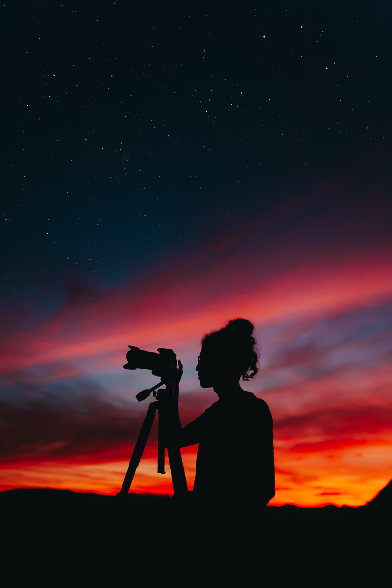 Silhouette of Woman Photographer Using Camera at Night, by Matheu Bertelli on pexels.com