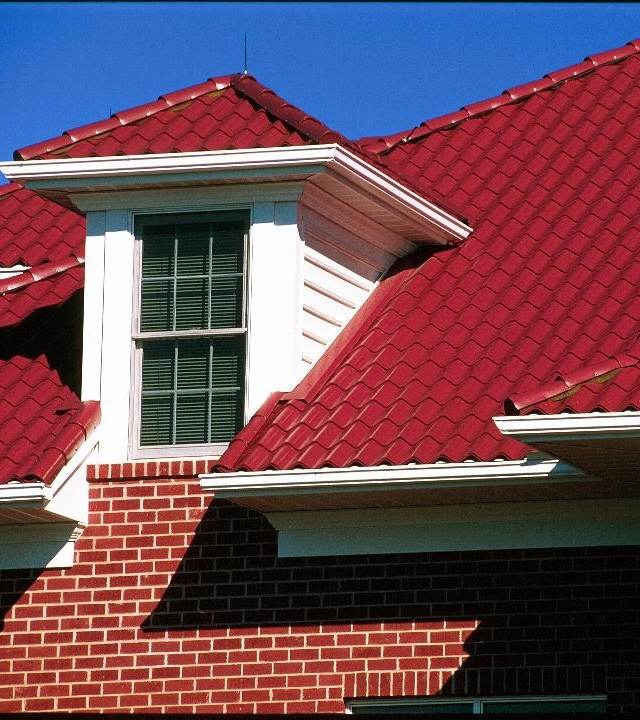 Red metal roof on a sustainable home