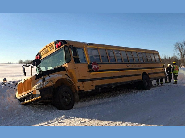 school bus stuck in the ditch filled with snow