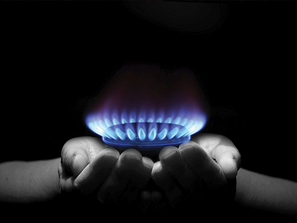 hands holding a natural gas burner