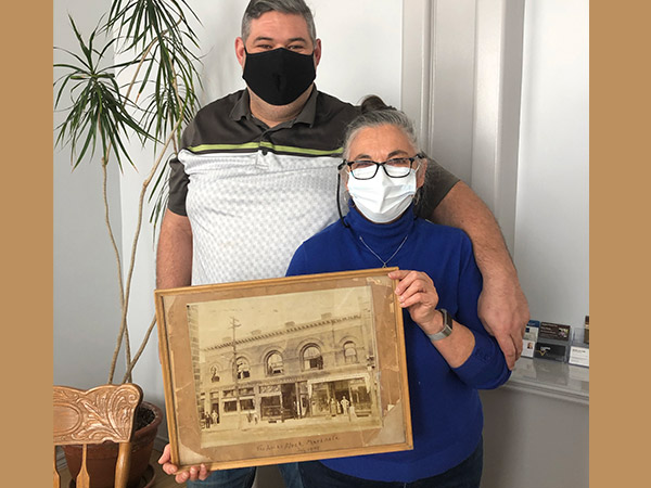 Eric and Graciela Robinson holding a heritage photo of Markdale
