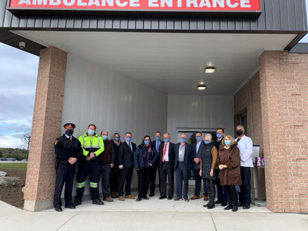 Local dignitaries standing in emergency entrance.