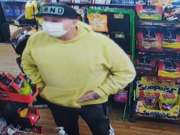 theft suspect in yellow hoodie and black hat.