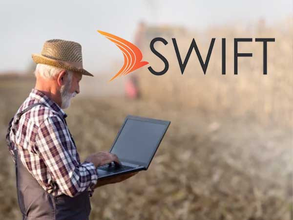 SWIFT logo with farmer accessing Internet background