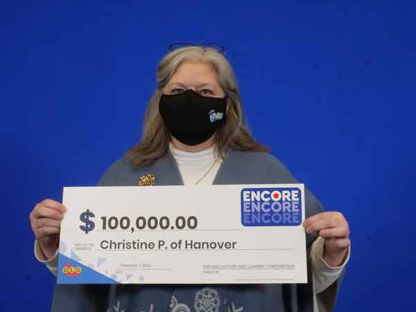 Christine Peschke holds large $100,000 cheque