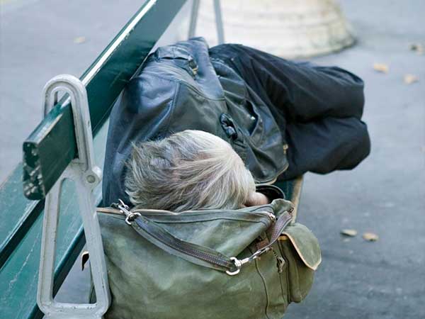 Person sleeping on bench