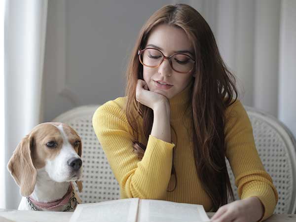 A girl reading to a dog