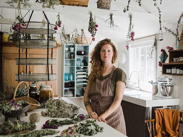 Sarah Tacoma with herbs in her kitchen