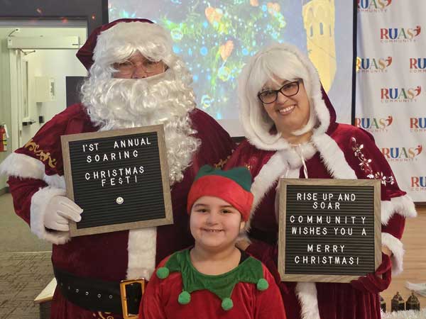 2023 RUAS Merry Christmas message brought by Santa, Mrs. Claus and an elf