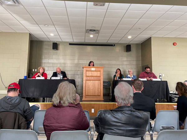 All candidates meeting, candidates sitting at table.