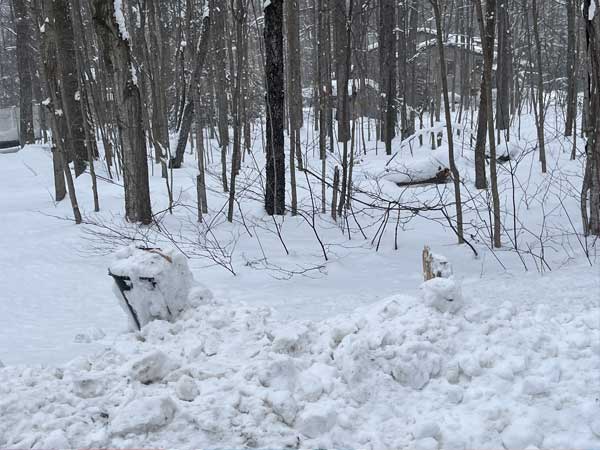 Broken mailbox covered in snow