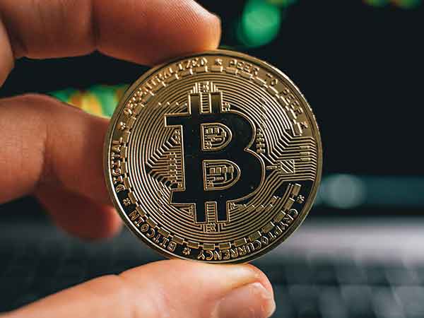 cryptocurrency coin held in hand.