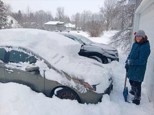 Snowy car being cleaned off