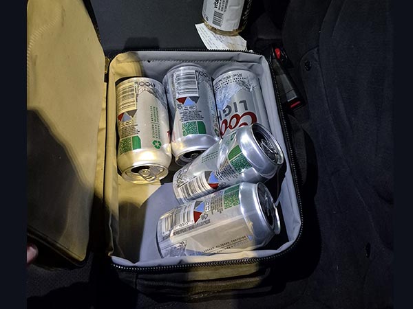 Opened beer cans in car.