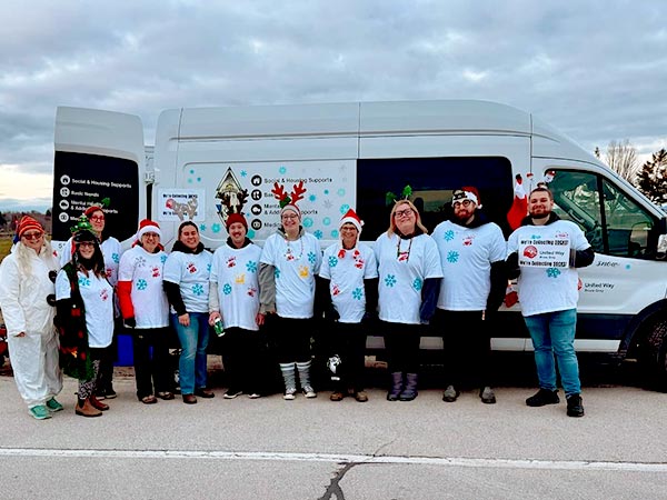 Sock drive volunteers lined up against van