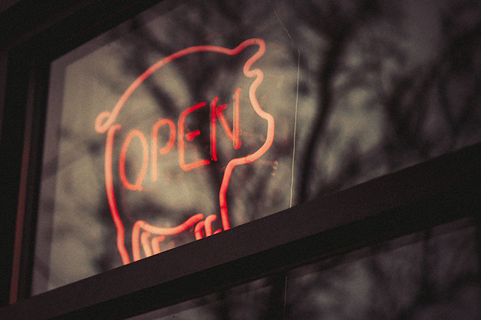 Neon Open sign glows at Louise Earl Butcher