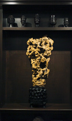 A yellow wax stone scholar's rock is found in the Ralph Lauren Home dining room / library
