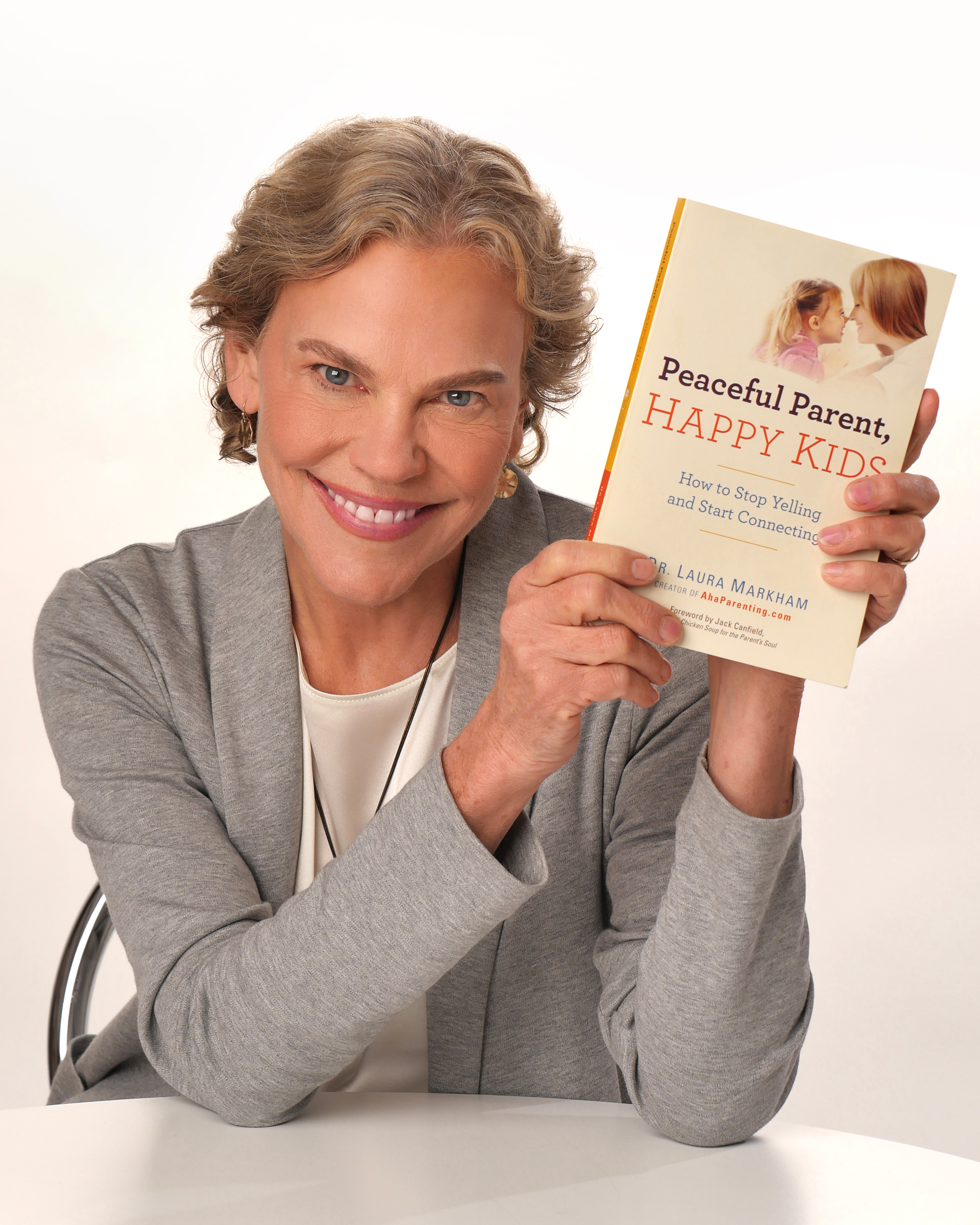 Dr. Laura Markham holding Peaceful Parent, Happy Kids