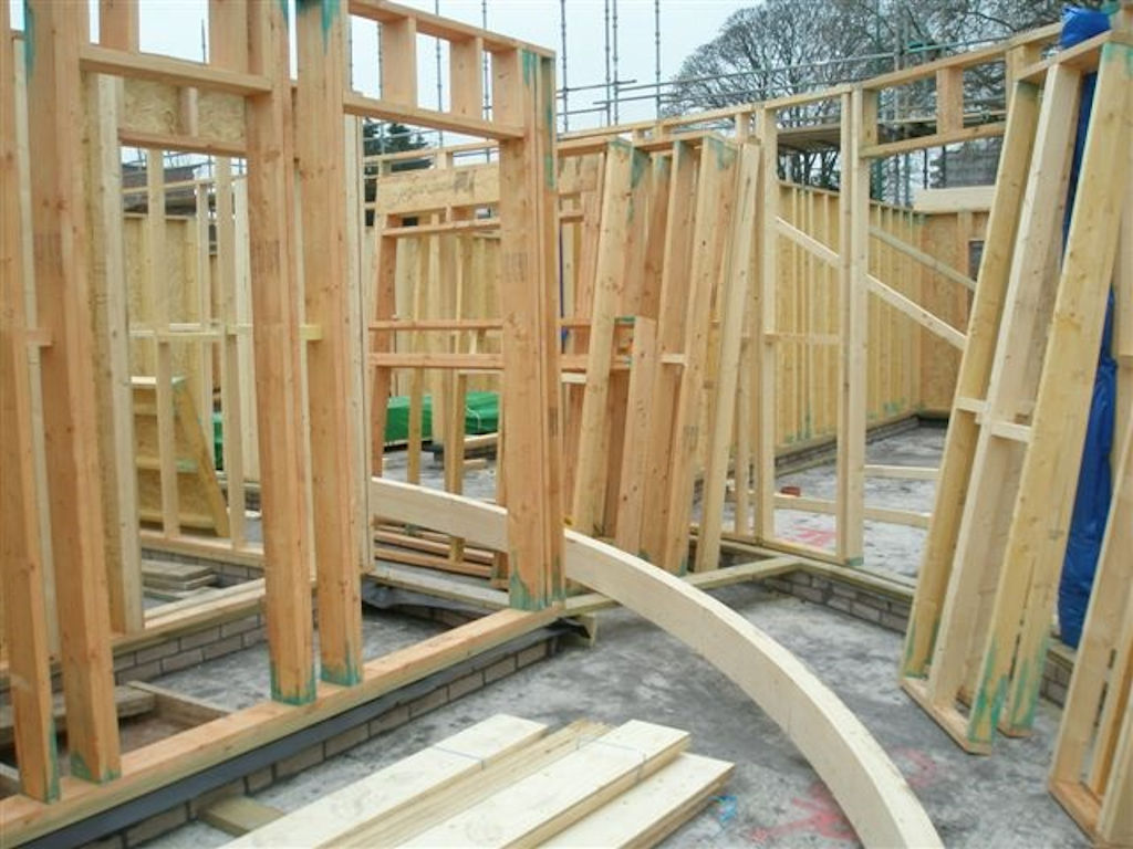 The complex radius timber frame structure takes shape.
